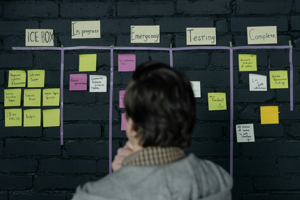 A man in an office reviews a scrum Trello board
